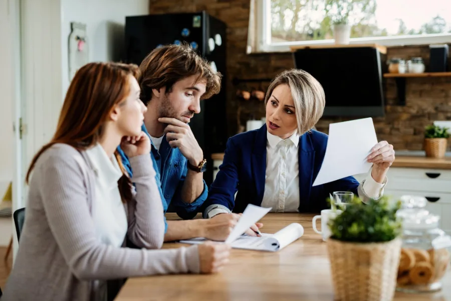 Claims handler reviewing documents with clients