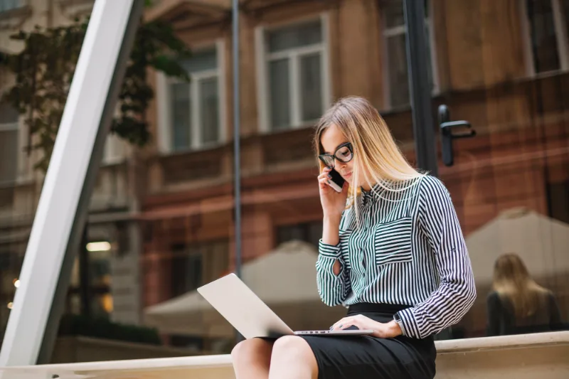 Underwriter on a phone call working on a laptop